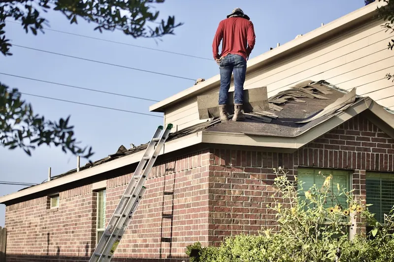 Professional roofer working on a residential roof in Pinehurst Trace